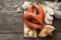 Smoked sausage with bread and spices on a wooden cutting board. Royalty Free Stock Photo