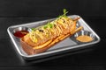 Smoked sausage corn dog with french fries, sweet chili and cheddar sauces