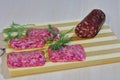 Smoked sausage with greens on a wooden board.