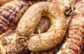 Smoked sausage on the heap of smoked meat. Close up Royalty Free Stock Photo