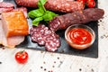 Smoked sausage, meat, bacon with basil and cherry tomatoes Royalty Free Stock Photo