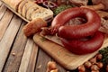 Smoked sausage with bread and spices on a old wooden table Royalty Free Stock Photo