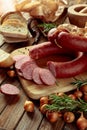 Smoked sausage with bread and spices on a old wooden table Royalty Free Stock Photo