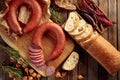 Smoked sausage with bread and spices on a old wooden table Royalty Free Stock Photo
