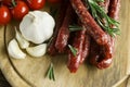 Smoked sausage with rosemary and peppercorns tomatoes and garlic Royalty Free Stock Photo