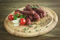 Smoked sausage with rosemary and peppercorns tomatoes and garlic Royalty Free Stock Photo