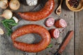 Smoked sausage with rosemary and spices on a wooden table