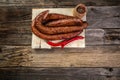 Smoked sausage on a wooden rustic table, natural product from organic farm, top view Food recipe background. space for text Royalty Free Stock Photo