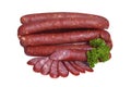 Smoked sausages decorated with sprig of parsley. Isolated on white background Royalty Free Stock Photo