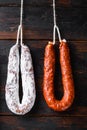 Smoked sausages meat hanging on wooden background Royalty Free Stock Photo