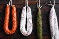 Smoked sausages meat hanging on wooden surface Royalty Free Stock Photo