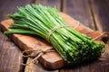 smoked scallions bundled and tied on a wooden board