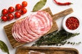 Smoked sliced sausage, on white stone table background, top view flat lay Royalty Free Stock Photo