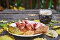 Smoked and slowly roasted pork knuckle with pint of dark beer. Royalty Free Stock Photo