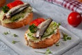 Smoked sprat sandwich - fish fresh cucumber and tomato. Sprat sandwiches on toasted slices of bread