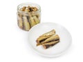 Smoked sprats with vegetable oil in glass jar and saucer Royalty Free Stock Photo