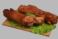 Smoked trotters on wooden board. Royalty Free Stock Photo