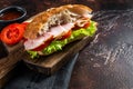 Smoked turkey sandwich with ham, cheese, tomato and Lettuce. Dark background. Top view. Copy space Royalty Free Stock Photo