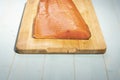 Smoked wild sockeye salmon on wooden cutting board