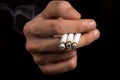 Smoker holding three cigarettes Royalty Free Stock Photo
