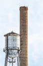 Smokestack and water tower for abandoned sugar mill Royalty Free Stock Photo