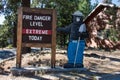 Smokey the Bear mascot to prevent forest fires warns that there is an extreme fire danger