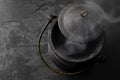 Smoking Black Iron Cauldron on a Dark Gray Slate Background