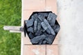 Smoking charcoal chimney starter bucket for barbecue Royalty Free Stock Photo