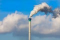 Smoking chimney against the blue sky