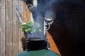 Smoking chimney from a BGE barbecue in a garden