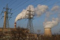 Smoking chimney of thermal power station and high voltage electric pole and transmission lines Royalty Free Stock Photo