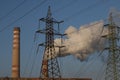 Smoking chimney of thermal power station and high voltage electric pole and transmission lines Royalty Free Stock Photo