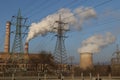 Smoking chimney of thermal power station and high voltage electric pole and transmission lines Royalty Free Stock Photo