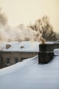 Smoking chimneys during cold and sunny winter day