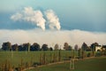 Smoking chimneys in from factory hidden in mist Royalty Free Stock Photo