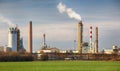 Smoking chimneys of a petrochemical factory in an oil refinery Royalty Free Stock Photo