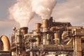 Smoking chimneys pipes and silos of a chemical complex of a factory