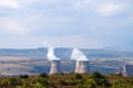 Smoking chimneys of a thermal power plant against the backdrop of a mountainous landscape in Bulgaria Royalty Free Stock Photo