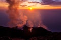 Smoking erupting volcano on Stromboli island at colorful sunset, Sicily Royalty Free Stock Photo