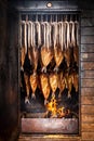 Smoking fish filets hanging side by side in a smoker