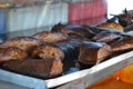 Smoking fish hanging side by side. Salmon fish Royalty Free Stock Photo