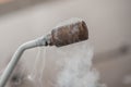 Smoking frozen pipe for liquid nitrogen Royalty Free Stock Photo