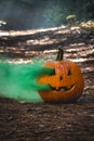 Smoking jack o\' lantern in the forest