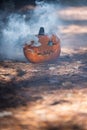Smoking jack o\' lantern in the forest