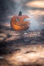 Smoking jack o\' lantern in the forest