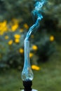 A smoking old kerosene lamp on a green grass. Royalty Free Stock Photo