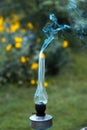 A smoking old kerosene lamp on a green grass. Royalty Free Stock Photo