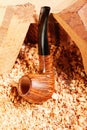 Smoking pipe leaning on wood