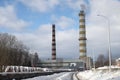 Smoking pipes of heating plant supplying heat to city, power station with three smoke stacks. Royalty Free Stock Photo