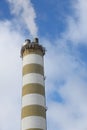 Smoking pipes of heating plant supplying heat to city, power station with three smoke stacks. Royalty Free Stock Photo